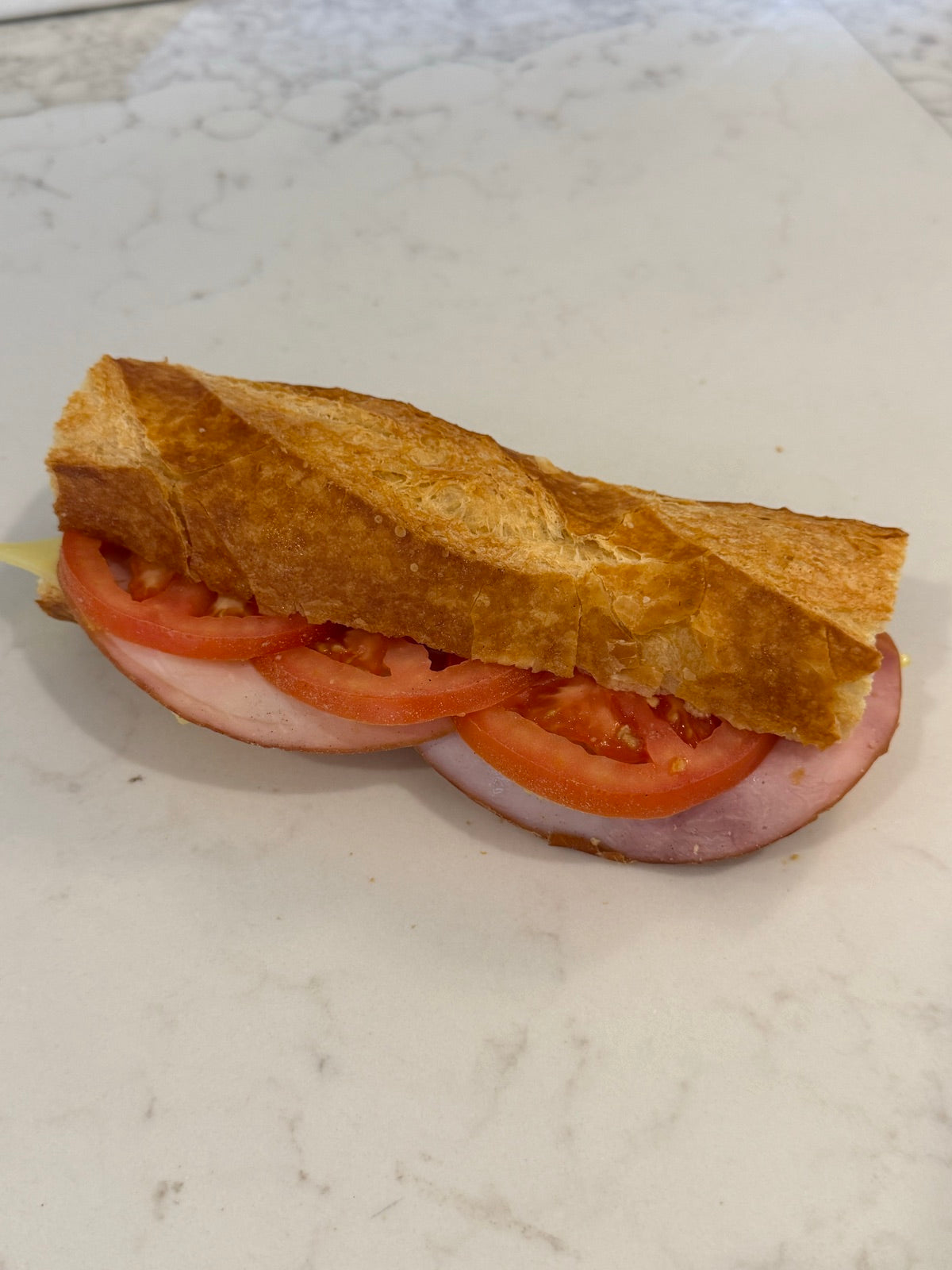 A Le 76 ham and cheese baguette made on bread baked that morning