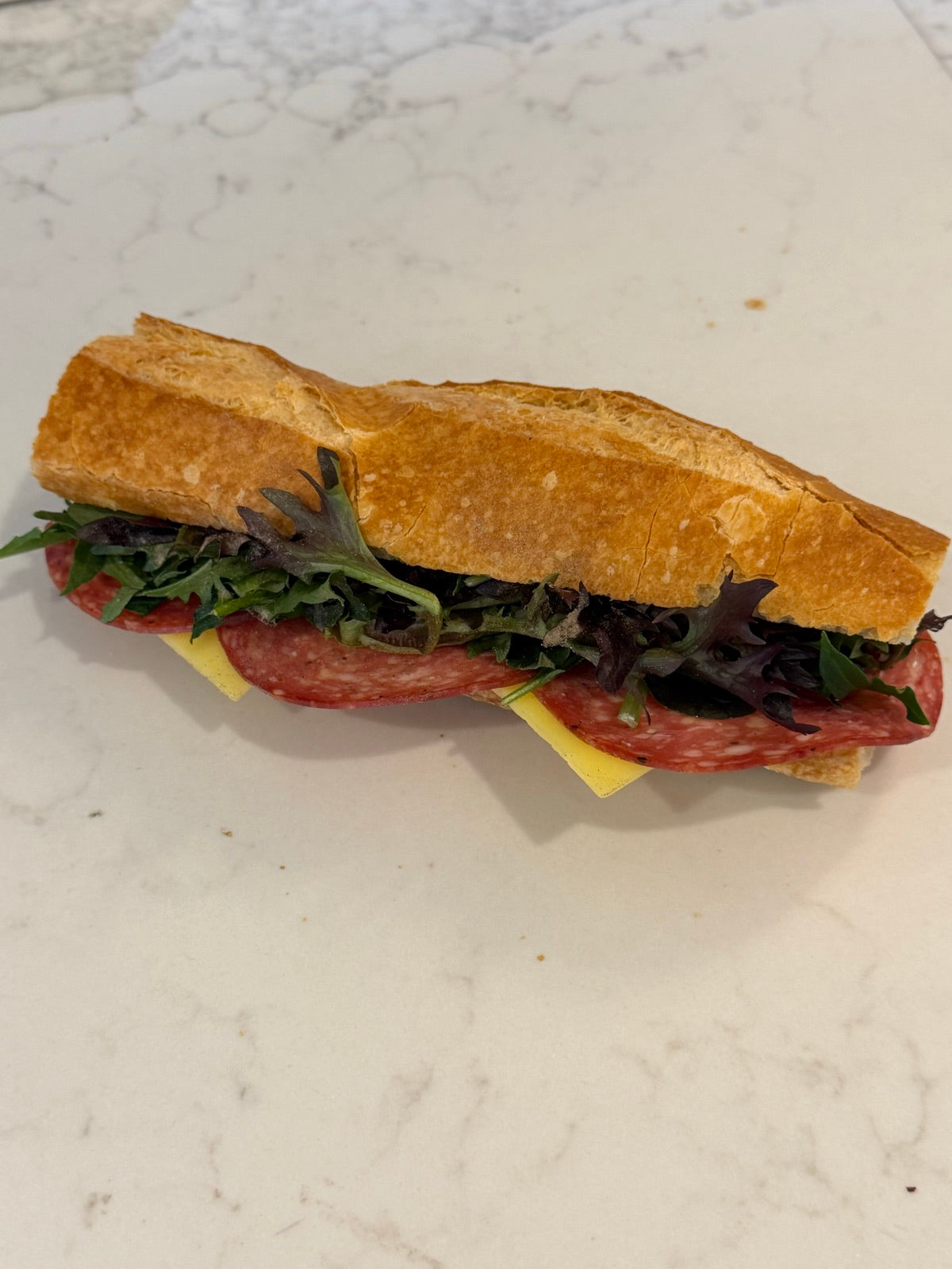 A Le 76 salami baguette with salad