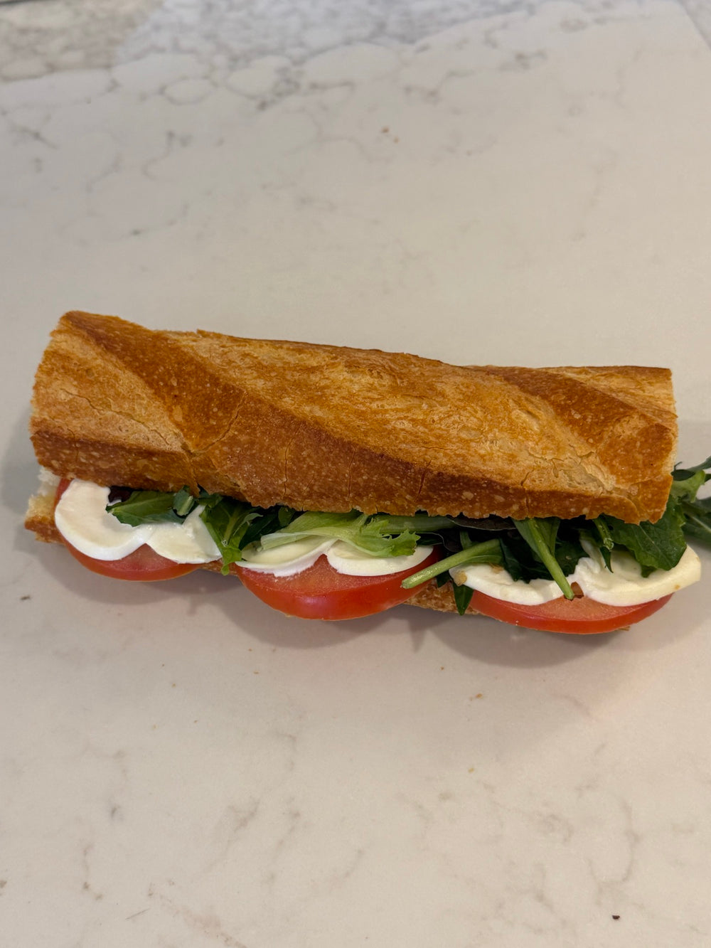 A Le 76 bocconcini baguette with tomato and basil
