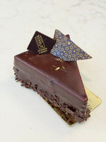 A slice of Le 76 gluten free chocolate mousse cake with a mirror glaze