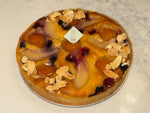 A whole Le 76 frangipane tart with pears, berries and flaked almonds