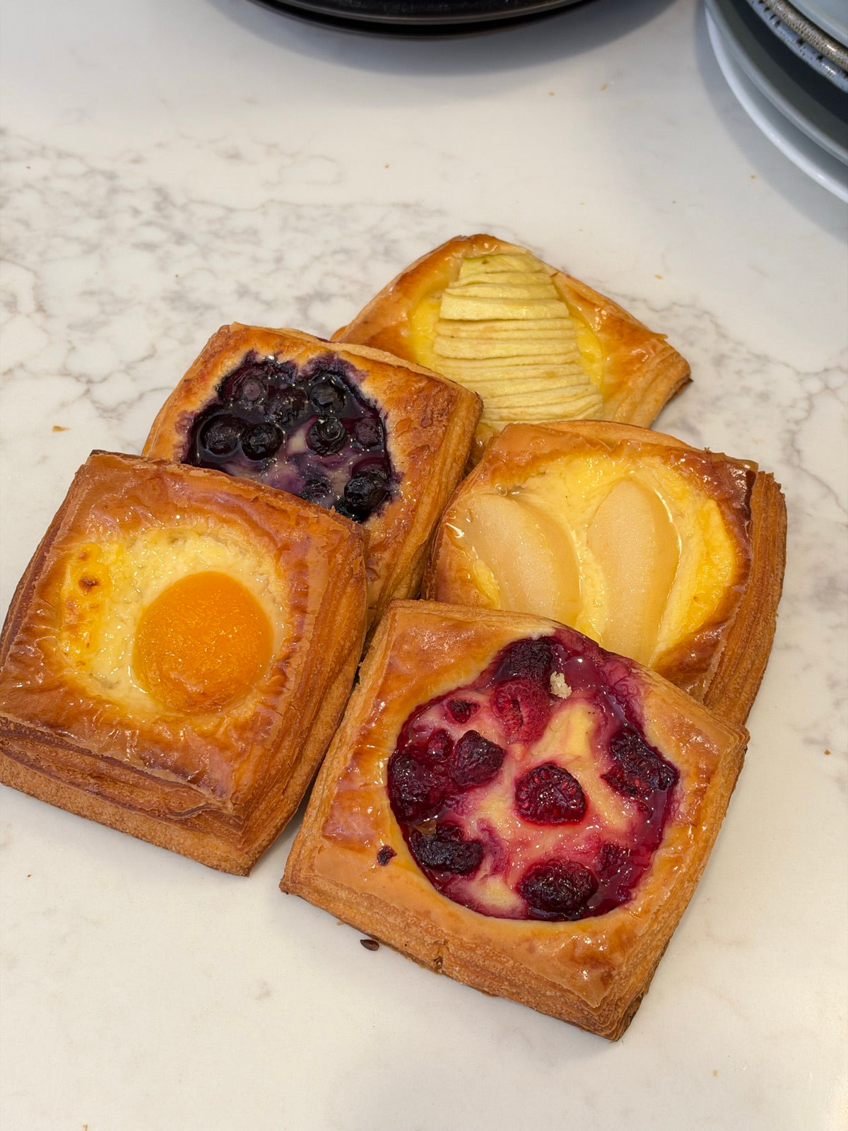 A selection of Le 76 mini danishes with pear, berry and apricot