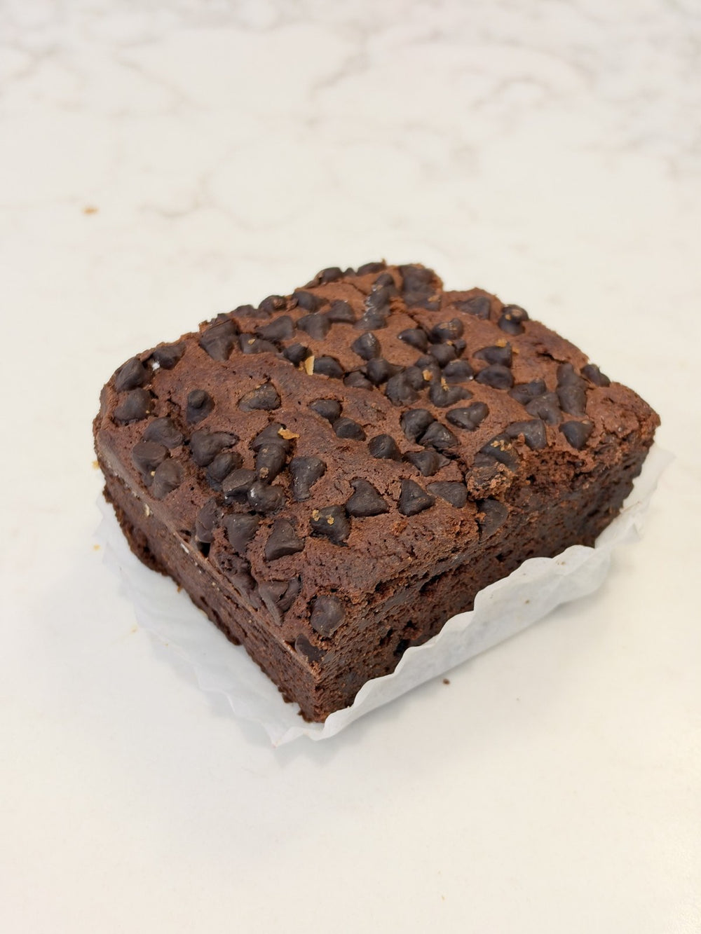 A Le 76 dark chocolate brownie, dense in the middle