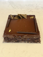 A whole Le 76 gluten free chocolate mousse cake on a flourless base