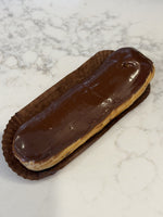 A Le 76 chocolate eclair, choux pastry filled by hand and glazed in dark chocolate