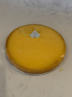 A whole Le 76 lemon tart, smooth lemon curd set in thin sweet pastry