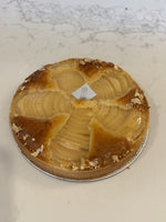 A whole Le 76 pear and almond tart, pear halves fanned in frangipane with flaked almonds