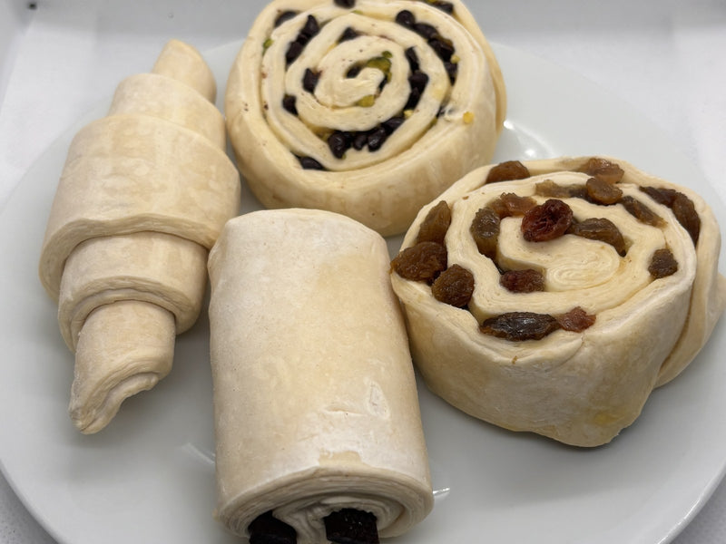 Le 76 frozen raw pastries, a raw croissant and cinnamon scrolls ready to bake
