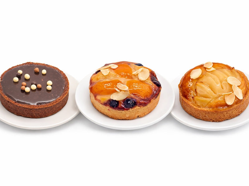 Three Le 76 wholesale tarts, chocolate ganache, mixed berry and pear and almond