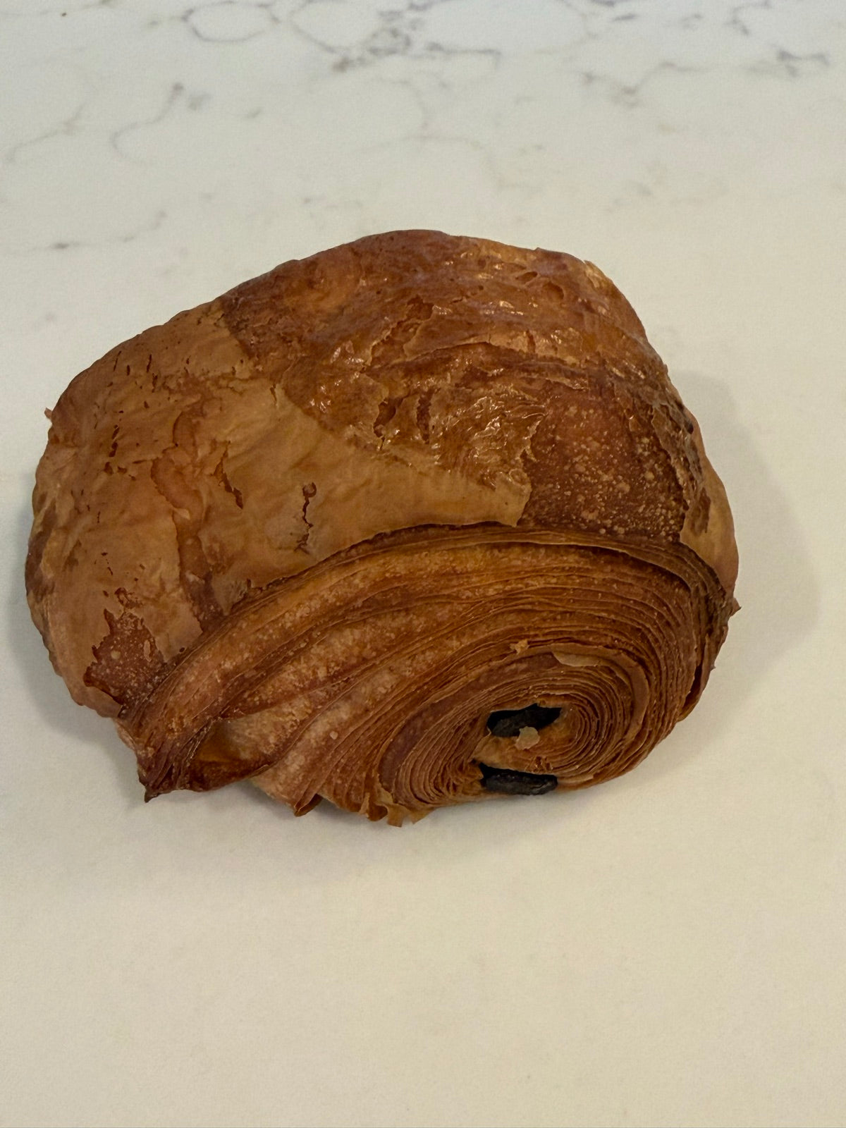 A Le 76 pain au chocolat, rolled around dark chocolate batons