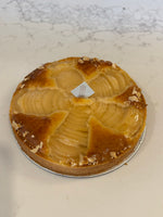 A whole Le 76 pear and almond tart, pear halves fanned in a circle