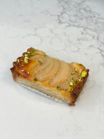 A Le 76 pear and pistachio slice, topped with poached pear and chopped pistachio