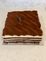 A whole Le 76 tiramisu, combed and dusted with cocoa